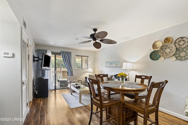 dining space with hardwood / wood-style flooring and ceiling fan