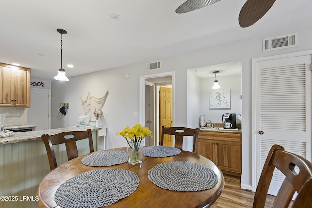 dining area featuring ceiling fan and light hardwood / wood-style floors