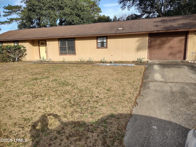 ranch-style home with a garage and a front yard