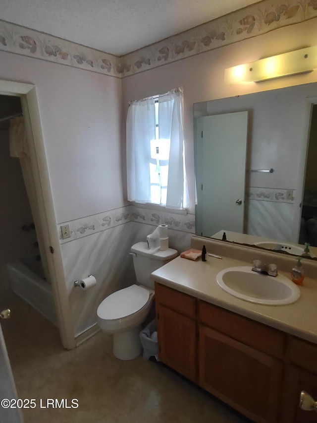 bathroom featuring vanity, a textured ceiling, and toilet