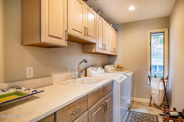 laundry area with cabinets, sink, and washer and dryer