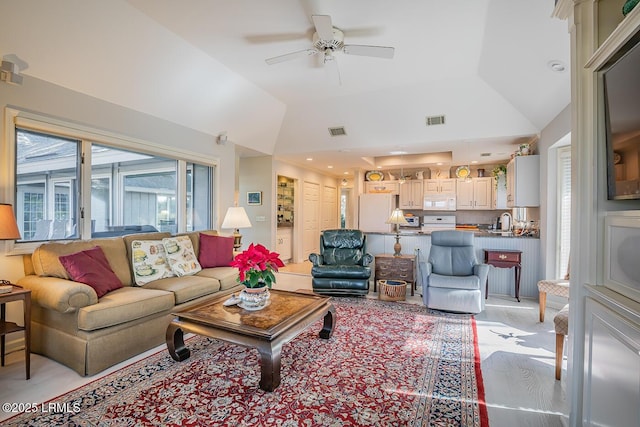 living room featuring vaulted ceiling and ceiling fan