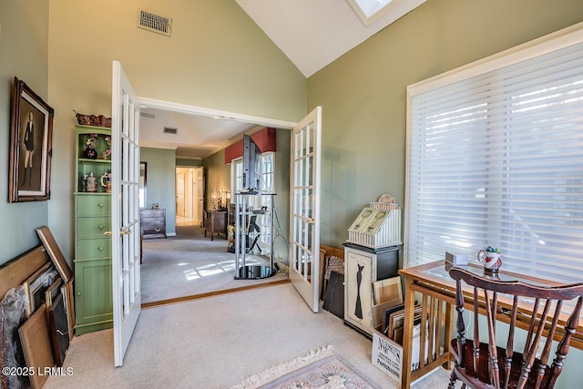 corridor featuring carpet floors, high vaulted ceiling, and french doors