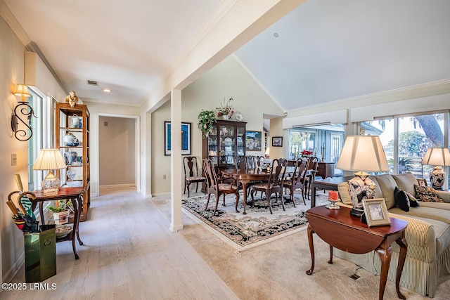 dining area featuring crown molding and light wood-type flooring