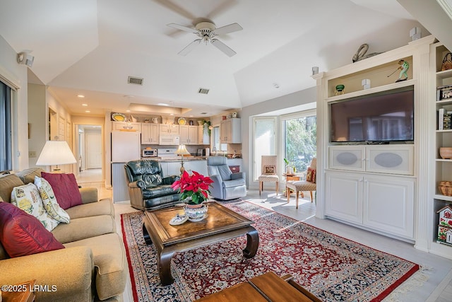 living room with ceiling fan and high vaulted ceiling