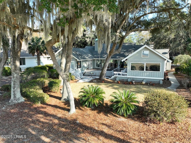 rear view of property featuring a yard