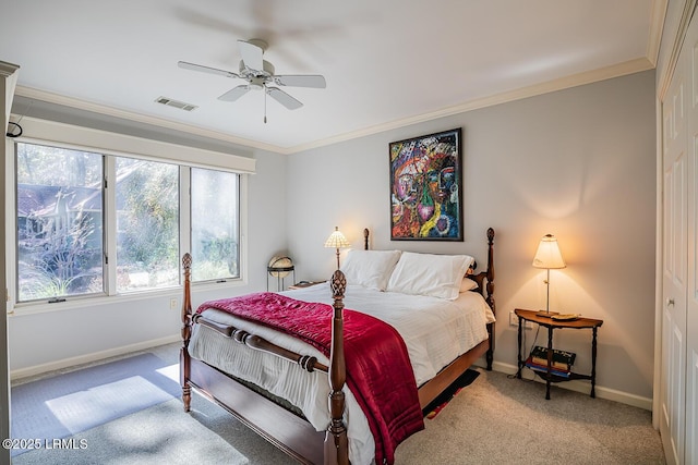 carpeted bedroom featuring ceiling fan and ornamental molding