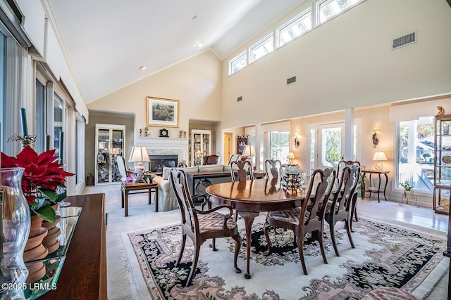 dining area featuring vaulted ceiling and light colored carpet