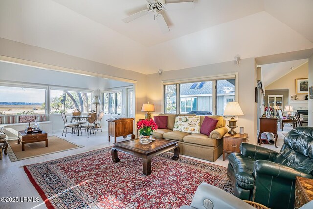 living room featuring hardwood / wood-style floors, lofted ceiling, a wealth of natural light, and ceiling fan