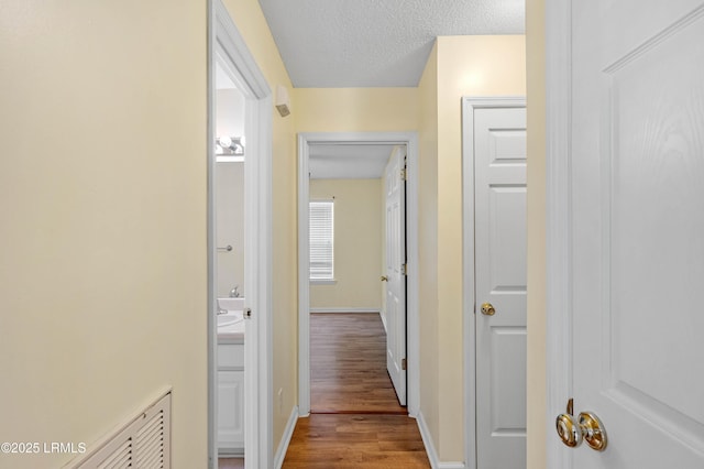 16 Star Magnolia Ct, Beaufort, SC 29907 - hallway with wood finished floors, baseboards, and a textured ceiling