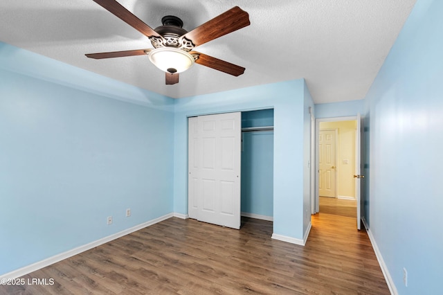 16 Star Magnolia Ct, Beaufort, SC 29907 - unfurnished bedroom with wood finished floors, a closet, baseboards, a textured ceiling, and a ceiling fan