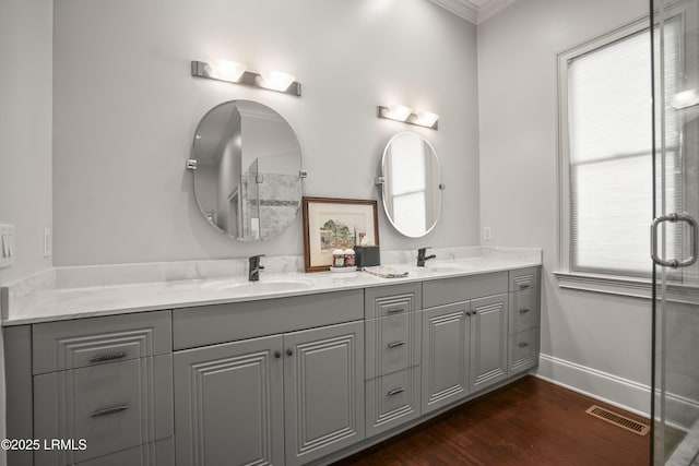 105 Bartram Dr, Beaufort, SC 29902 - bathroom featuring double vanity, an enclosed shower, wood finished floors, and ornamental molding
