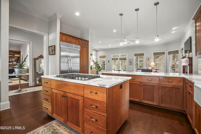 105 Bartram Dr, Beaufort, SC 29902 - kitchen featuring stainless steel appliances, a peninsula, ceiling fan, dark wood-style floors, and brown cabinetry