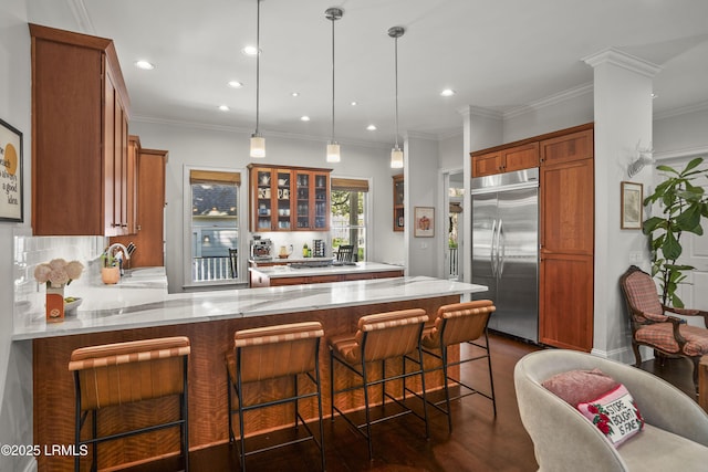 105 Bartram Dr, Beaufort, SC 29902 - kitchen featuring built in fridge, a peninsula, glass insert cabinets, light stone countertops, and recessed lighting