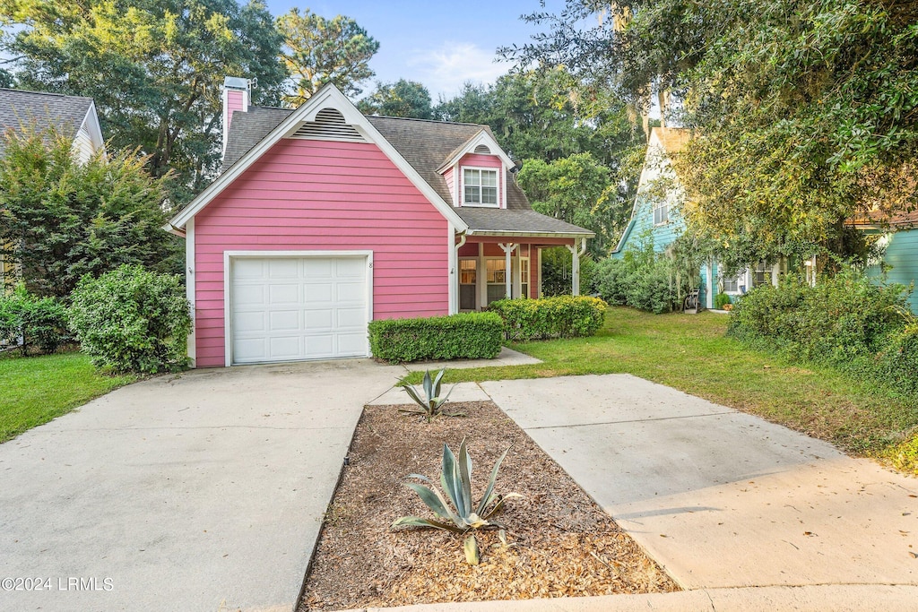 view of front facade featuring a porch, a garage, and a front lawn