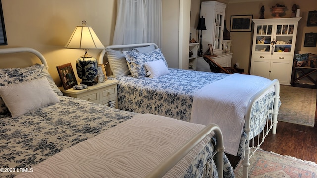 bedroom featuring dark hardwood / wood-style flooring