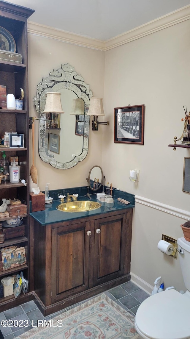 bathroom with crown molding, vanity, tile patterned floors, and toilet