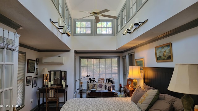 bedroom with multiple windows, crown molding, a wall mounted air conditioner, and ceiling fan