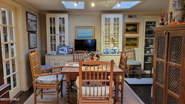 dining space featuring a skylight and ornamental molding