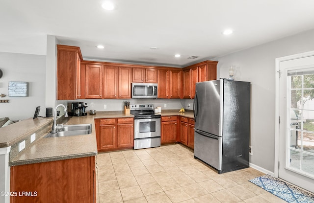 31 Shadow Moss Dr, Beaufort, SC 29906 - kitchen with stainless steel appliances, recessed lighting, brown cabinets, and a sink