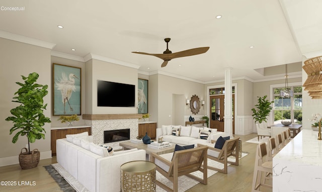 living room with a ceiling fan, a glass covered fireplace, recessed lighting, light wood-style floors, and decorative columns