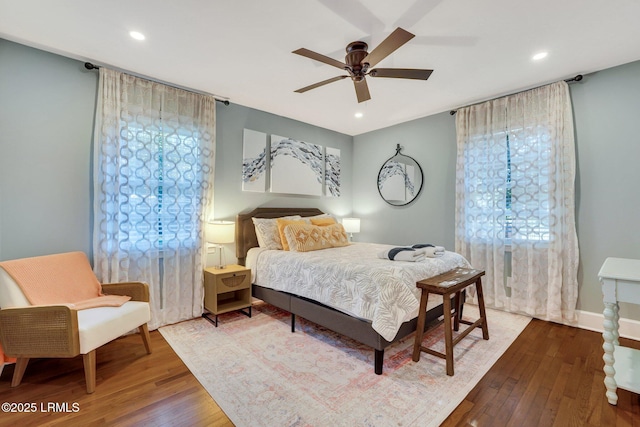 bedroom with baseboards, ceiling fan, recessed lighting, and wood-type flooring