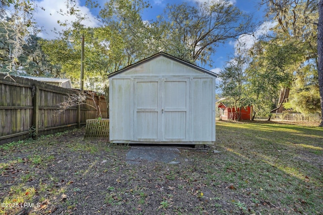 view of shed featuring fence