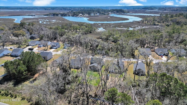 bird's eye view featuring a view of trees, a water view, and a residential view