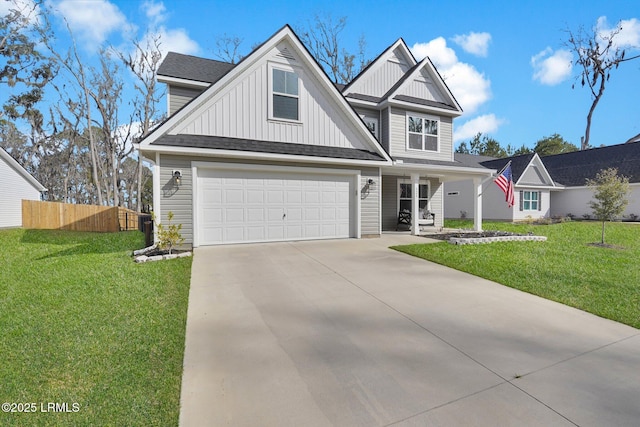 view of front of house with an attached garage, board and batten siding, fence, a front yard, and driveway