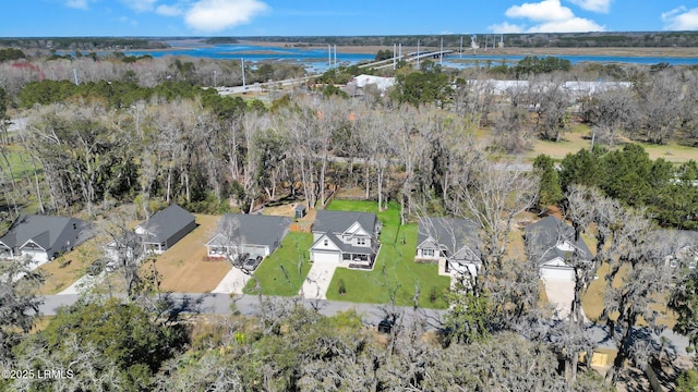 birds eye view of property featuring a view of trees, a water view, and a residential view