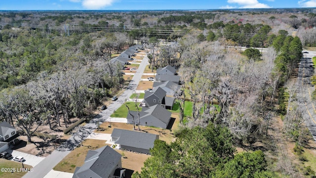 drone / aerial view with a forest view and a residential view