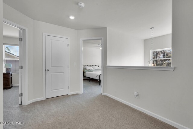 unfurnished bedroom with recessed lighting, baseboards, and carpet floors