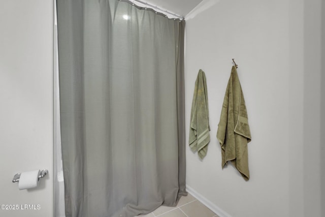 bathroom featuring curtained shower and tile patterned floors