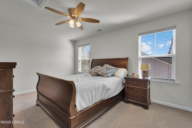 bedroom featuring visible vents, baseboards, light colored carpet, and a ceiling fan