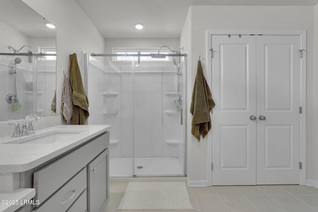 full bath with tile patterned floors, a stall shower, and vanity