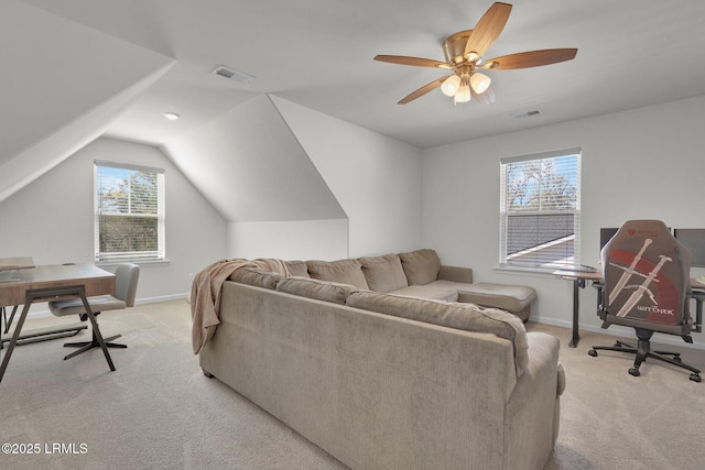 living area featuring visible vents, light carpet, baseboards, and vaulted ceiling