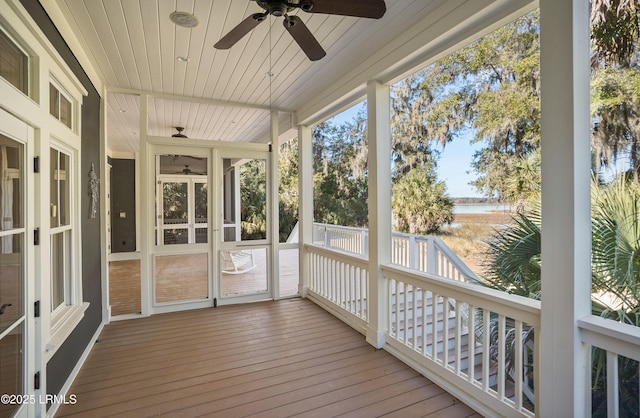 unfurnished sunroom with ceiling fan and wooden ceiling