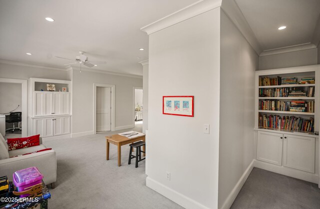 interior space featuring ornamental molding and carpet