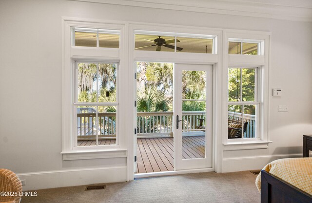 doorway featuring carpet and ceiling fan