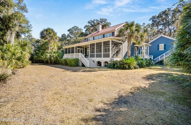 rear view of property with a sunroom