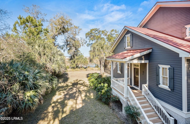 view of side of property with a porch