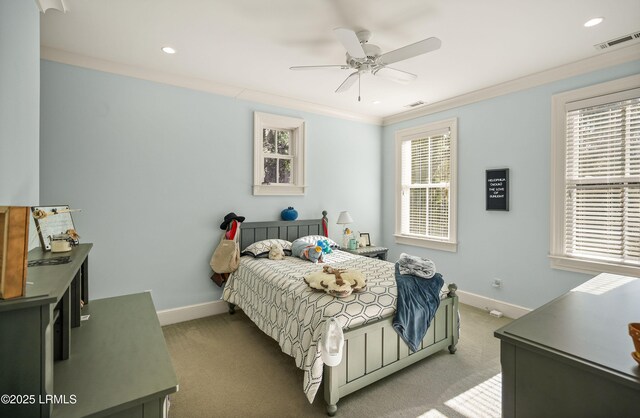 carpeted bedroom with ornamental molding and ceiling fan