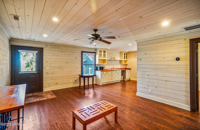 living room featuring wood ceiling, wooden walls, and hardwood / wood-style flooring