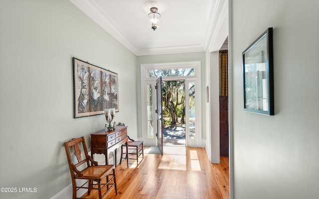 entryway featuring crown molding and light wood-type flooring