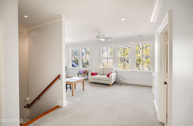 interior space with crown molding, plenty of natural light, light colored carpet, and ceiling fan