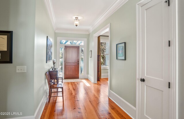 entrance foyer with ornamental molding and light wood-type flooring