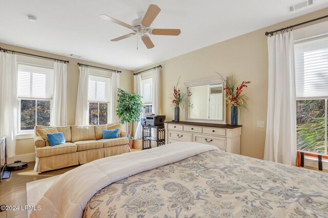 bedroom with ceiling fan and hardwood / wood-style floors