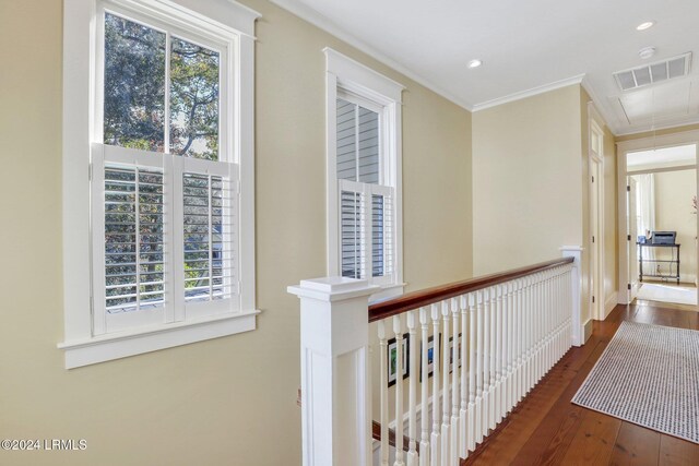 corridor featuring crown molding and dark hardwood / wood-style flooring