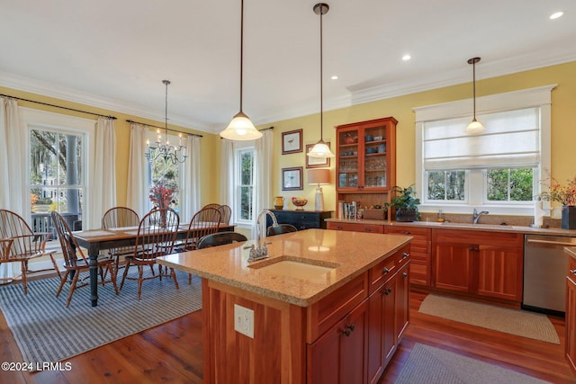 kitchen with sink, light stone counters, decorative light fixtures, a center island with sink, and dishwasher