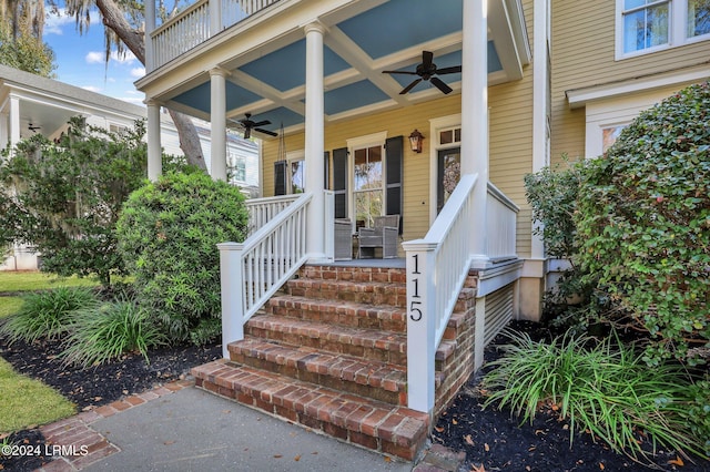 entrance to property featuring a balcony, ceiling fan, and covered porch